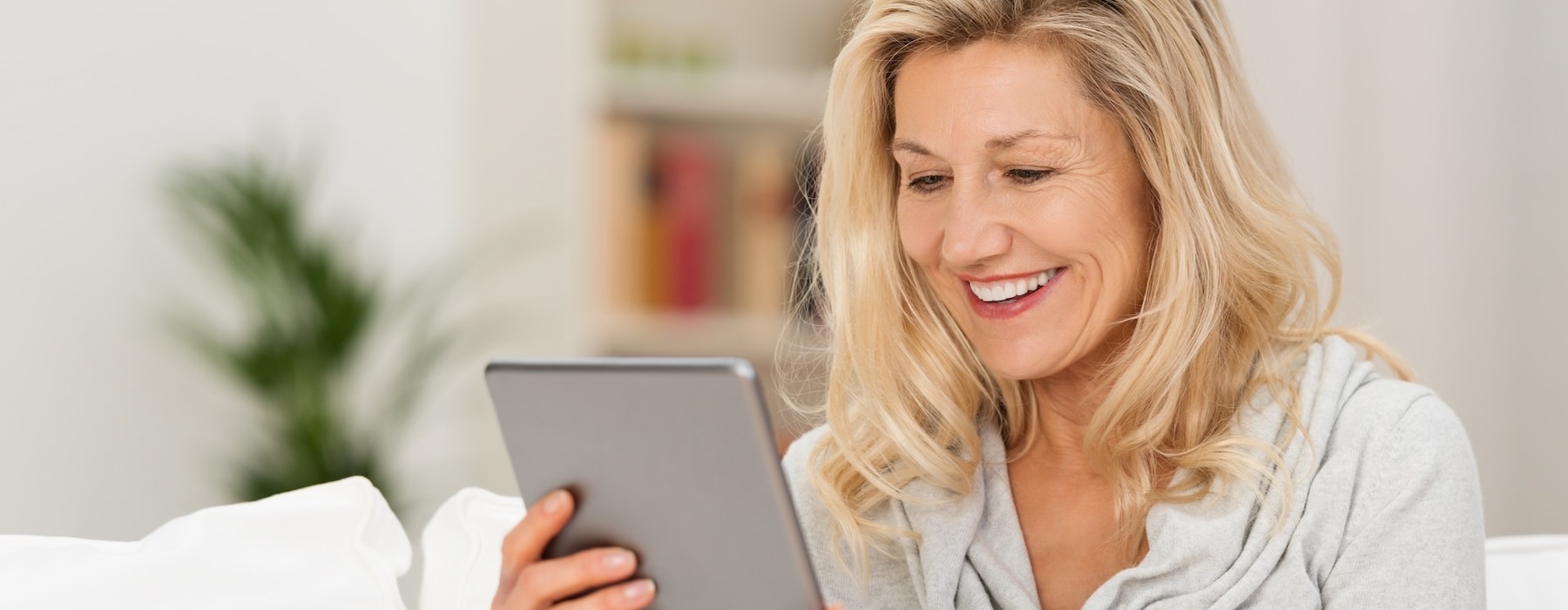 a woman looking at a tablet